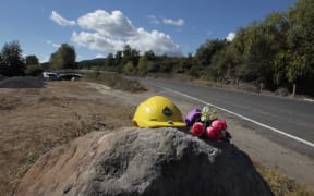 Flowers and a hard hat have been placed near the site where Mr Taiaroa was killed.