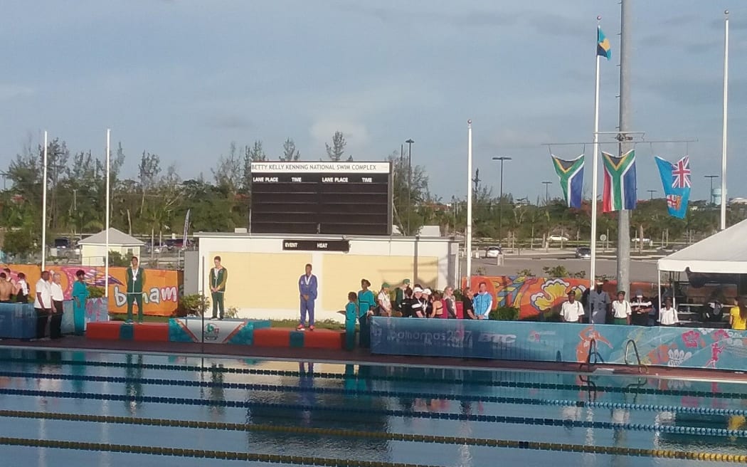 Fiji swimmer Taichi Vakasama receives his bronze medal at the Commonwealth Youth Games.
