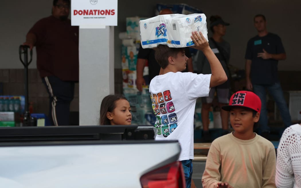 KAHULUI, HAWAII - AUGUST 10: Volunteers with King's Cathedral Maui bring in donations on August 10, 2023 in Kahului, Hawaii. Dozens of people were killed and thousands displaced after a wind-driven wildfire devastated the town of Lahaina on Tuesday. King's Cathedral Maui is providing food and shelter for displaced families.   Justin Sullivan/Getty Images/AFP (Photo by JUSTIN SULLIVAN / GETTY IMAGES NORTH AMERICA / Getty Images via AFP)