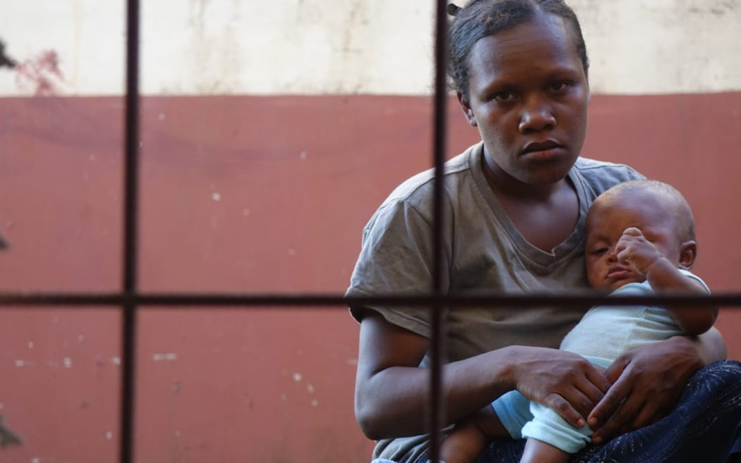 A mother and infant who happened to be outside the national immunization storage facility.