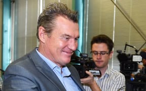Sir John Kirwan smiles as he leaves the media conference announcing his resignation