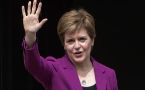 First Minister Nicola Sturgeon waves on the steps of her official residence  in Edinburgh following the SNP's victory in the Scottish parliament elections.