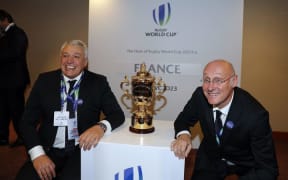 President of the French bid Claude Atcher (left) and French rugby President Bernard Laporte pose with the trophy after France was named to host the 2023 Rugby World Cup.