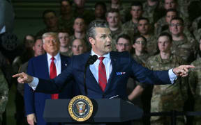 US Secretary of Defence, Pete Hegseth, speaks as US President Donald Trump (L) looks on during remarks to the Michigan National Guard at Selfridge Air National Guard Base in Warren, Michigan, on April 29, 2025. (Photo by Jim WATSON / AFP)