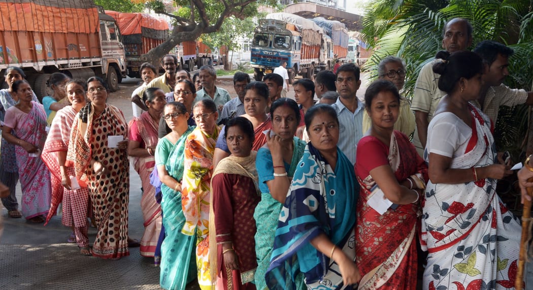 Voters waiting to cast their vote in Kolkata on Monday.