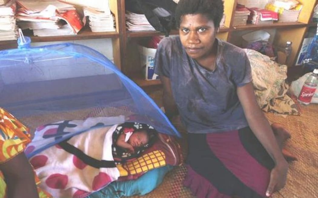 Atel Yalu with her baby Pamina, born the morning Cyclone Pam struck. Their home was destroyed  and the family's future is uncertain.