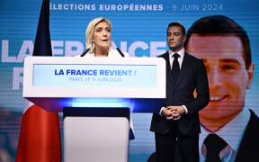 French far-right Rassemblement National (RN) party leader Marine Le Pen, left, gives a speech as party President Jordan Bardella listens, after French President announced he is calling for new general elections, 9 June 2024.