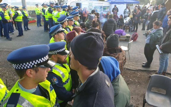 Police and some protesters at the site today.
