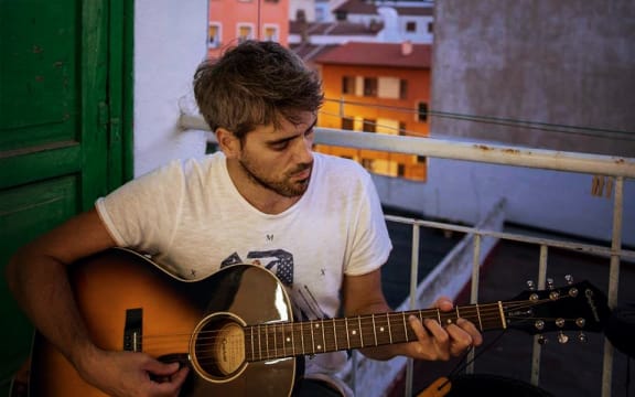 Johnny Barker playing his guitar