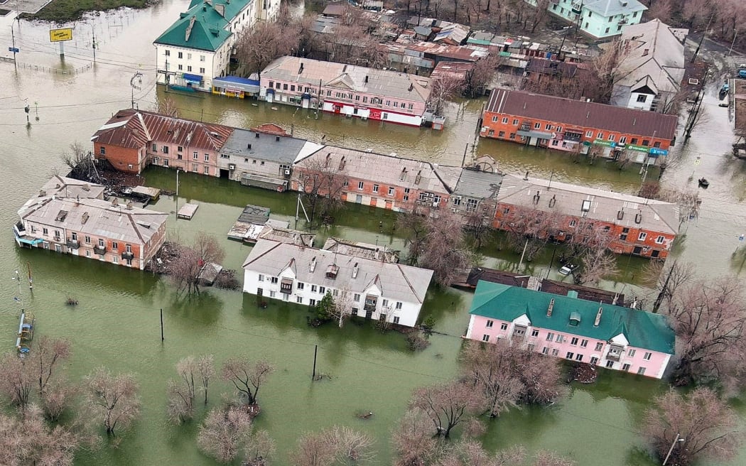 An aerial picture taken on April 8, 2024 shows the flooded part of the city of Orsk, Russia's Orenburg region, southeast of the southern tip of the Ural Mountains. Russia said on April 8, 2024 that more than 10,000 residential buildings were flooded across the Urals, Volga area and western Siberia as emergency services evacuated cities threatened by rising rivers. On April 7, Russia declared a federal emergency in the Orenburg region, where the Ural river flooded much of the city of Orsk and is now reaching dangerous levels in the main city of Orenburg. Much of the city of Orsk has been flooded after torrential rain burst a nearby dam. (Photo by Anatoliy Zhdanov / Kommersant Photo / AFP) / Russia OUT