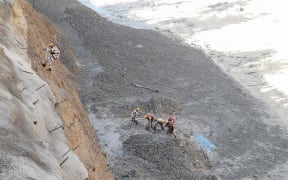 Indo Tibetan Border Police personnel work to clear Tapovan tunnel from debris following floods