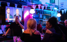 People attend a watch party at Madhatter for the vice presidential debate between Demcocrat Gov. Tim Walz (D-MN) and Republican Sen. J.D. Vance (R-OH) in Washington, DC, on October 1, 2024. (Photo by Allison Bailey/NurPhoto) (Photo by Allison Bailey / NurPhoto / NurPhoto via AFP)