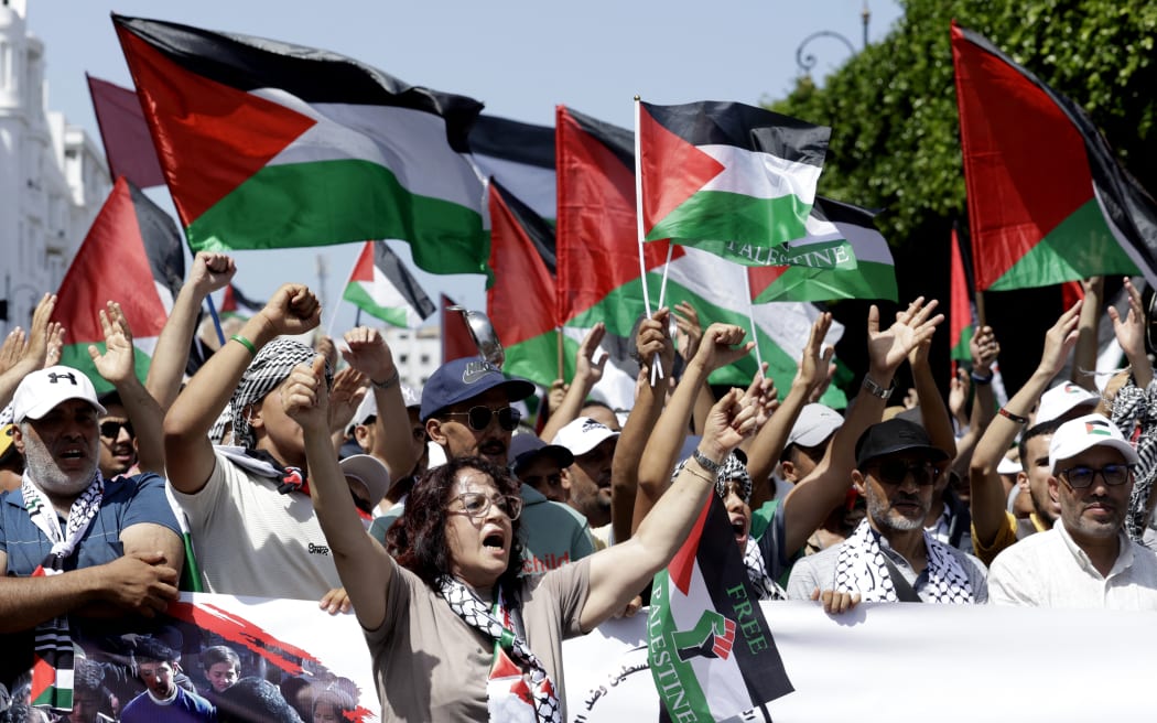 Moroccans chant slogans and wave the Palestinian flag during a march to express their solidarity with the Palestinians in the Gaza Strip, in Rabat on July 19, 2025.