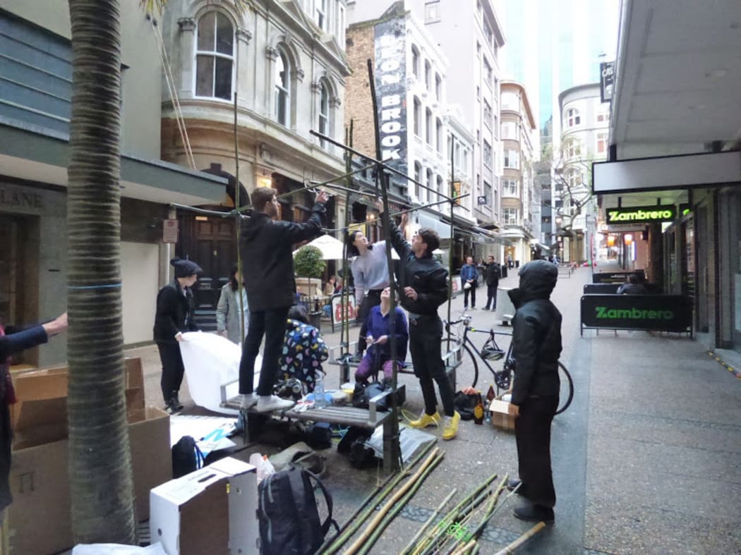 People assemble the Vulcan Lane sculpture (for the first time) before police asked council workers to remove it.