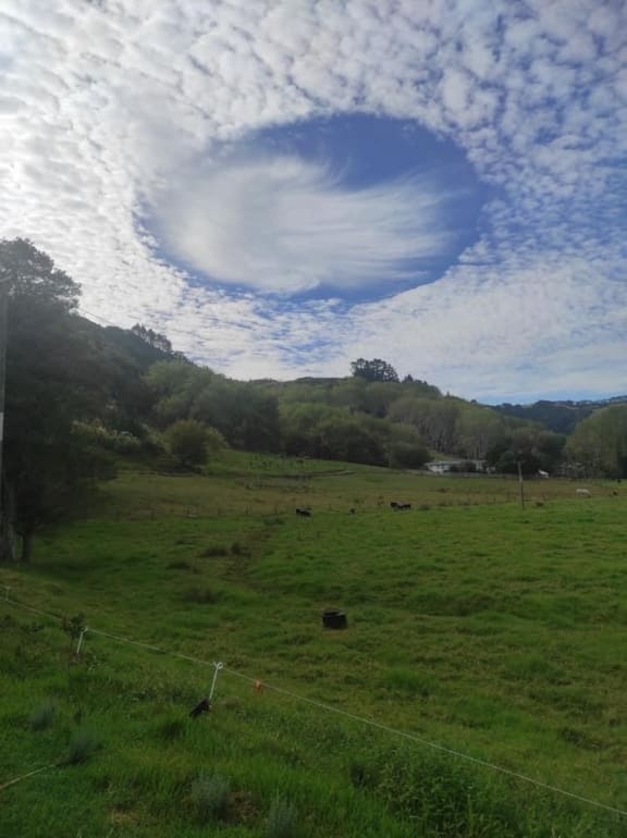 A cloud that looks like a UFO seen from Pakiri, Auckland.