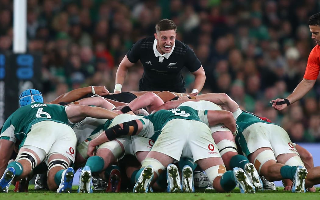 All Blacks halfback Cam Roigard encourages the pack during a scrum.