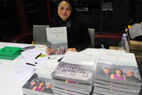 Justine Kohing selling copies at the launch