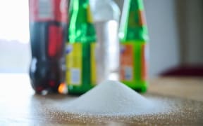 Different types of soft drinks and their bottles, on a table,