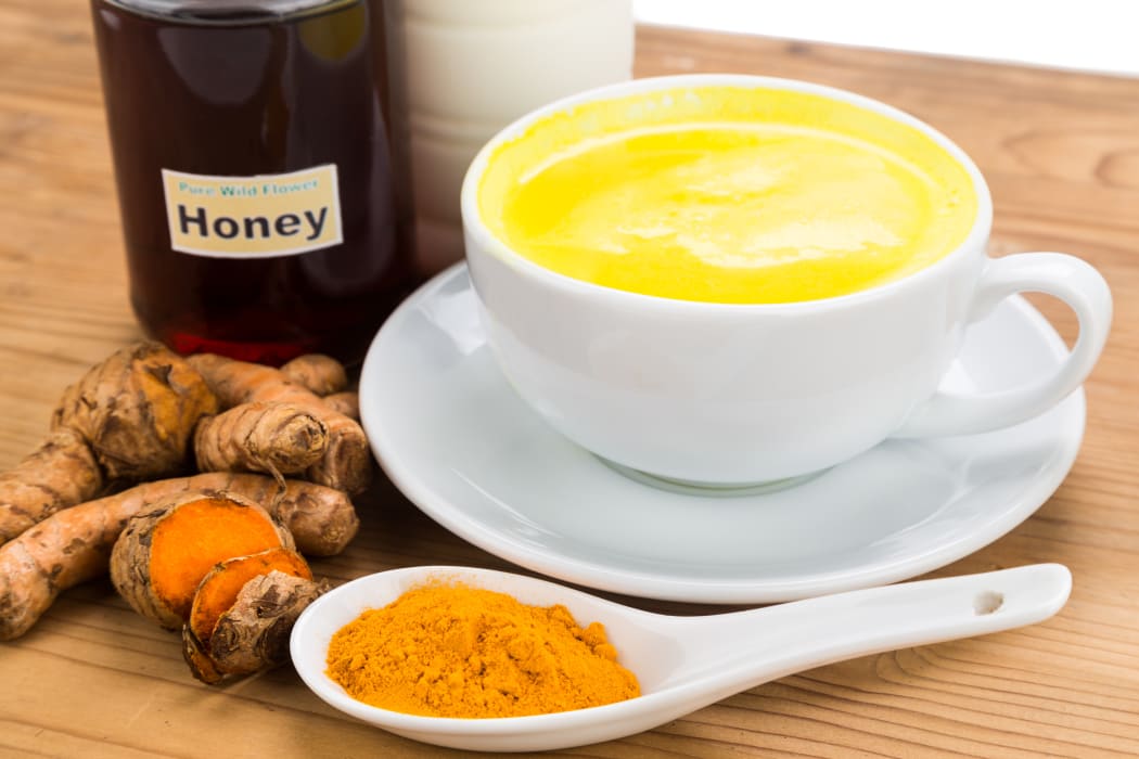 Turmeric roots with milk and honey drinks for beauty and health