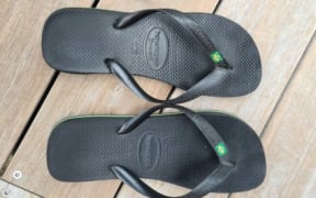 The three left-footed jandals on auction.