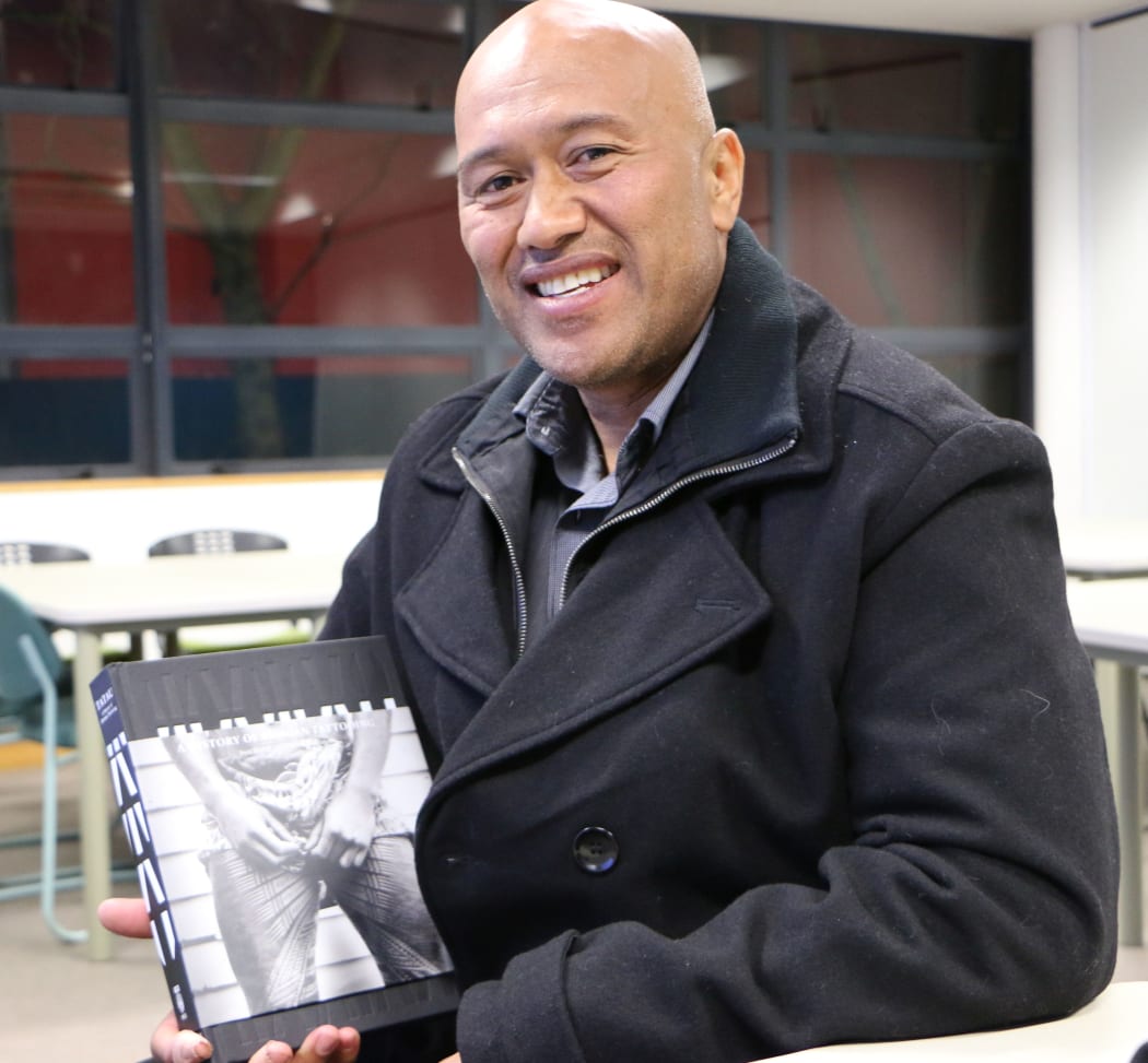 Alaelua Leasoiloaifaleupolu Taulapapa Malesala holds a copy of the new Tatau: A History of Samoan Tattooing book.
