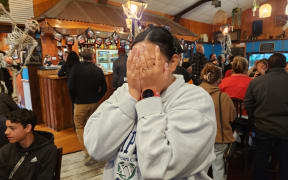 All Blacks fan Sophia Thomas of Te Tii reacts with disbelief at the Pioneer Tavern in Waipapa, as Sam Cane's yellow card is upgraded to red during the Rugby World Cup final between New Zealand and South Africa on 29 October, 2023.