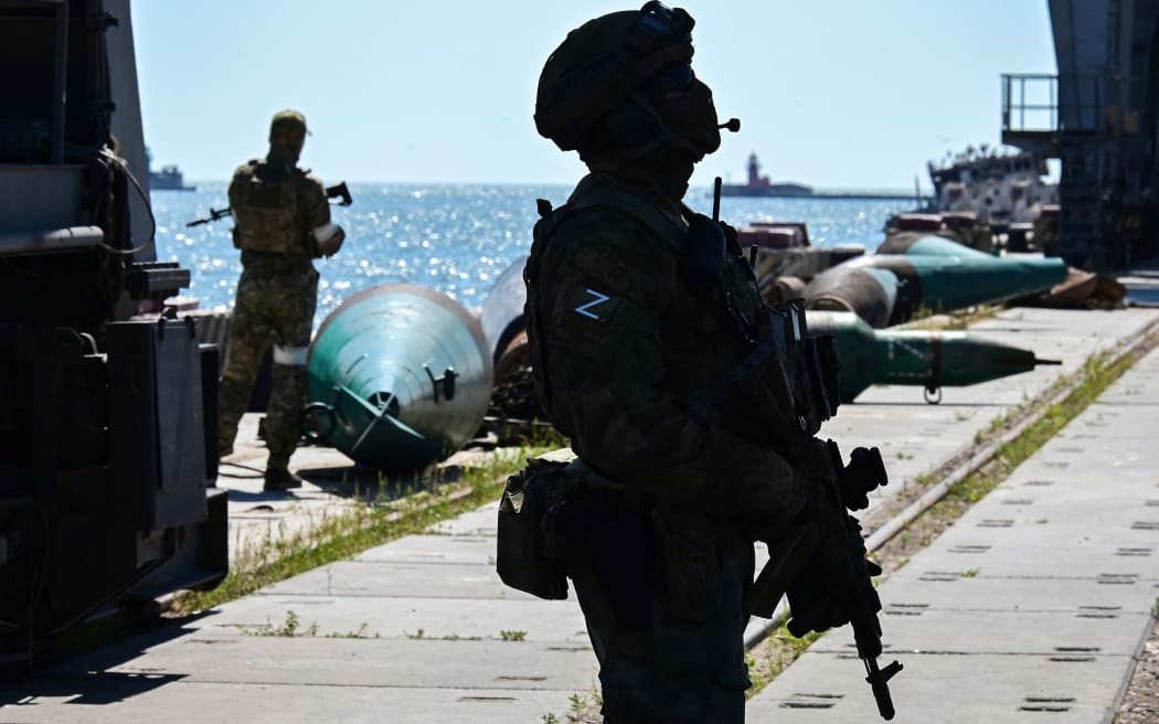 Russian soldiers patrol the sea port in the city of Mariupol on 12 June, 2022.