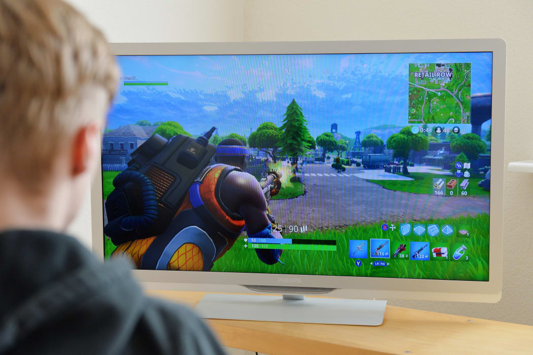 A boy plays Fortnite.