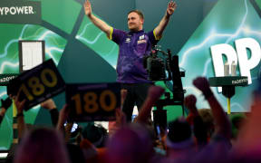 Luke Littler of England celebrates winning his quarter final match against Brendan Dolan of Ireland on day 14 of the World Darts Championship at Alexandra Palace.