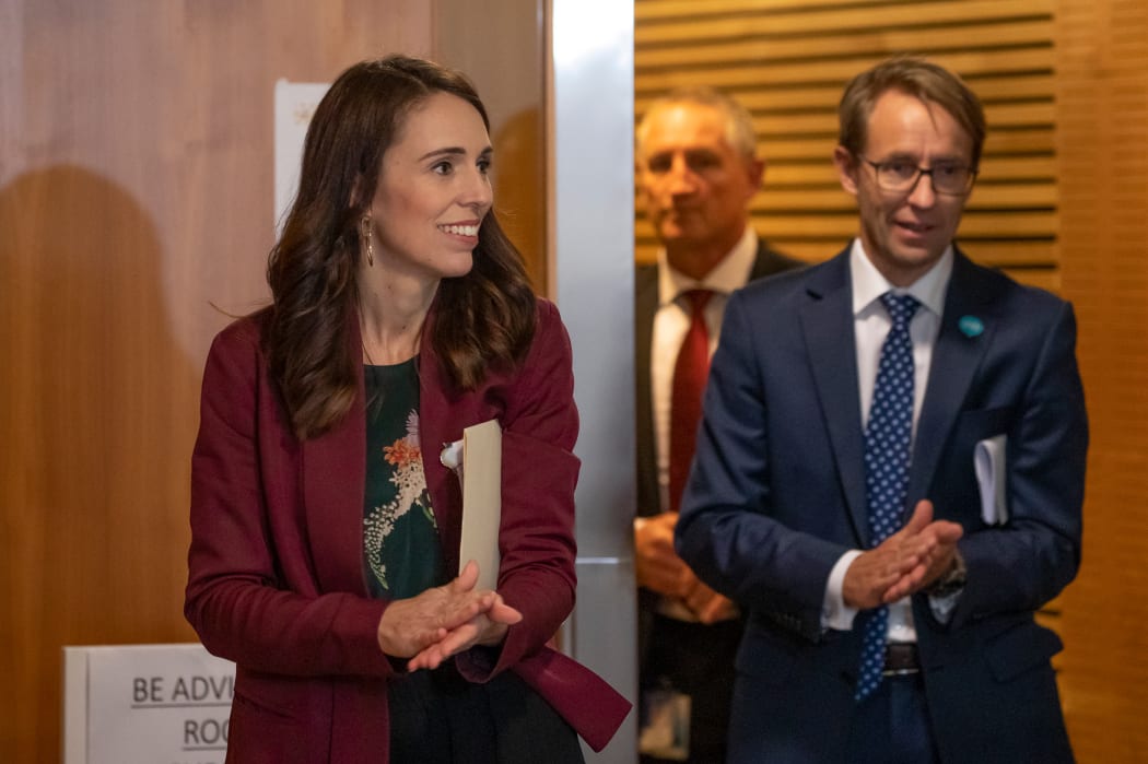 Prime Minister Jacinda Ardern sanitises her hands with Director-General of Health Dr Ashley Bloomfield while walking to a Covid-19 coronavirus briefing on 6 May, 2020.
