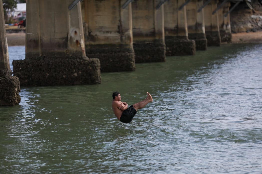 Popping a manu off Waitangi's one-lane bridge.