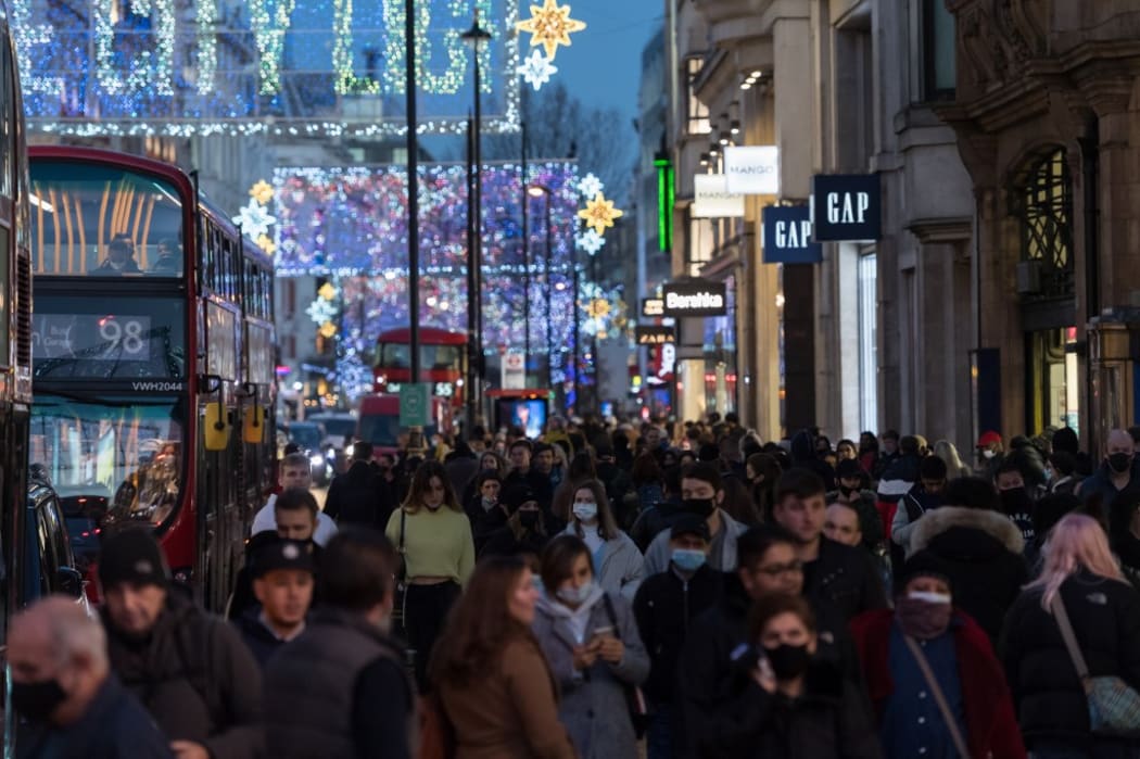 Crowds of shoppers and commuters walk along Oxford Street ahead of introduction of tougher coronavirus restrictions in the run up to Christmas, on 15 December, 2020 in London.