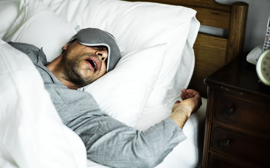 A man sleeping on a bed