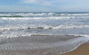 Waves rolling onto the beach at Ocean Beach, Hawkes Bay