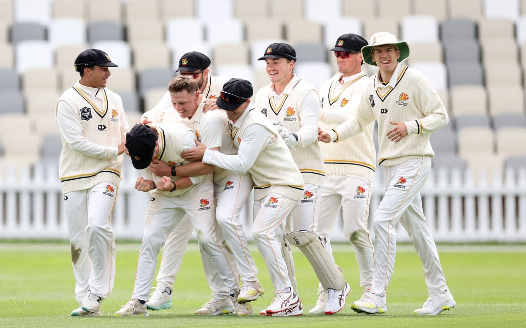 Wellington's Nick Kelly celebrates catching Canterbury's Cole McConchie with team mates during their Plunket Shield cricket match.