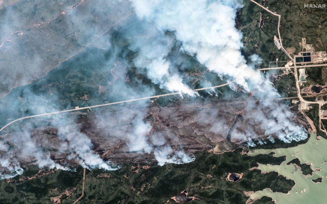 This handout satellite picture courtesy of Maxar Technologies shows  an overview of York Factory First Nation wildfire in Illford, Manitoba, Canada on May 30, 2025. Canada's wildfires, which have already forced evacuations of more than 26,000 people, continued their stubborn spread June 3, with heavy smoke choking millions of Canadians and Americans and reaching as far away as Europe.
Alerts were issued for parts of Canada and the neighboring United States warning of hazardous air quality. (Photo by Satellite image ©2025 Maxar Technologies / AFP) / RESTRICTED TO EDITORIAL USE - MANDATORY CREDIT "AFP PHOTO / HANDOUT / MAXAR TECHNOLOGIES " - NO MARKETING NO ADVERTISING CAMPAIGNS - DISTRIBUTED AS A SERVICE TO CLIENTS