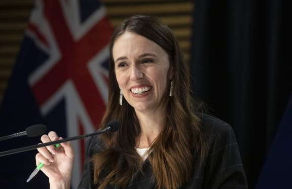 - POOL - Photo by Mark Mitchell.  Prime Minister Jacinda Ardern smiling during the post-Cabinet press conference with Energy Minister Megan Woods and Finance Minister Grant Robertson, Parliament, Wellington. 14 March, 2022.  NZ Herald photograph by Mark Mitchell
