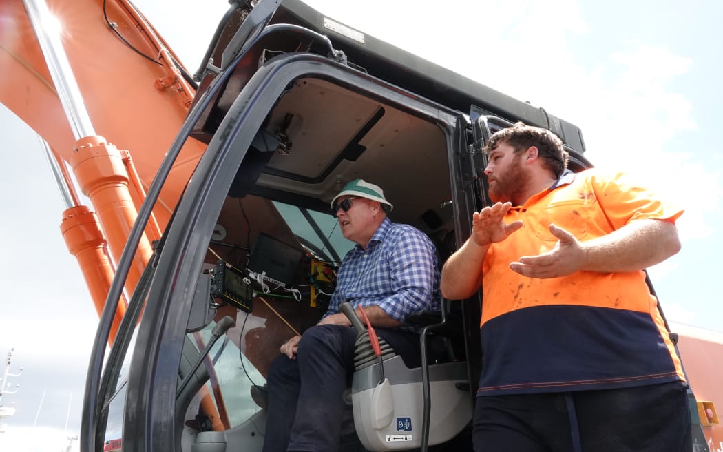 Johnson Brothers founder Andrew Johnson (right) runs through the suction dredge controls with Biosecurity NZ readiness and response director John Walsh.