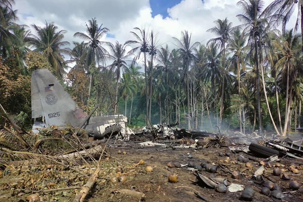 Smoke billows from the wreckage of a Philippine Airforce C-130 transport plane after it crashed near the airport in Jolo town, Sulu province on the southern island of Mindanao.
