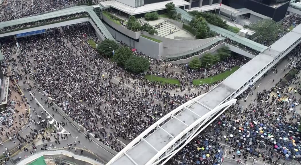 In this image made from aerial video, protesters gather in the streets outside the Legislative Council in Hong Kong, Wednesday, June 12, 2019.