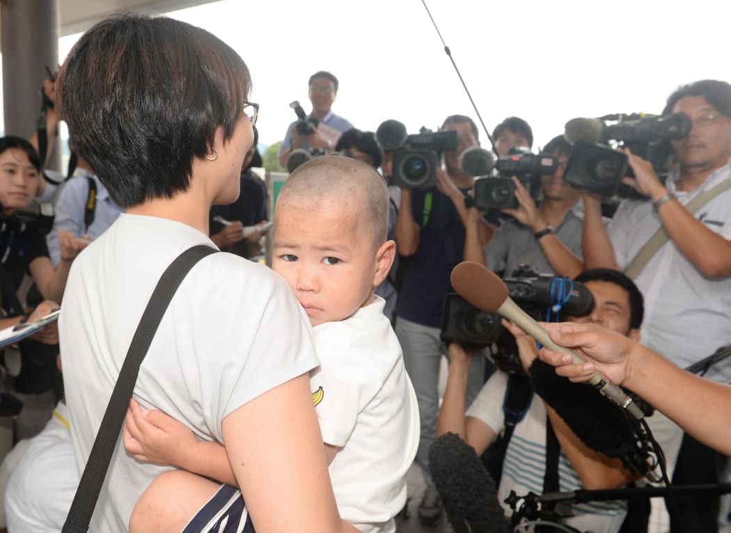 Yoshiki Fujimoto, who went missing for three days, leaves the hospital with his mother in Yanai City, Yamaguchi Prefecture on 20 August, 2018.