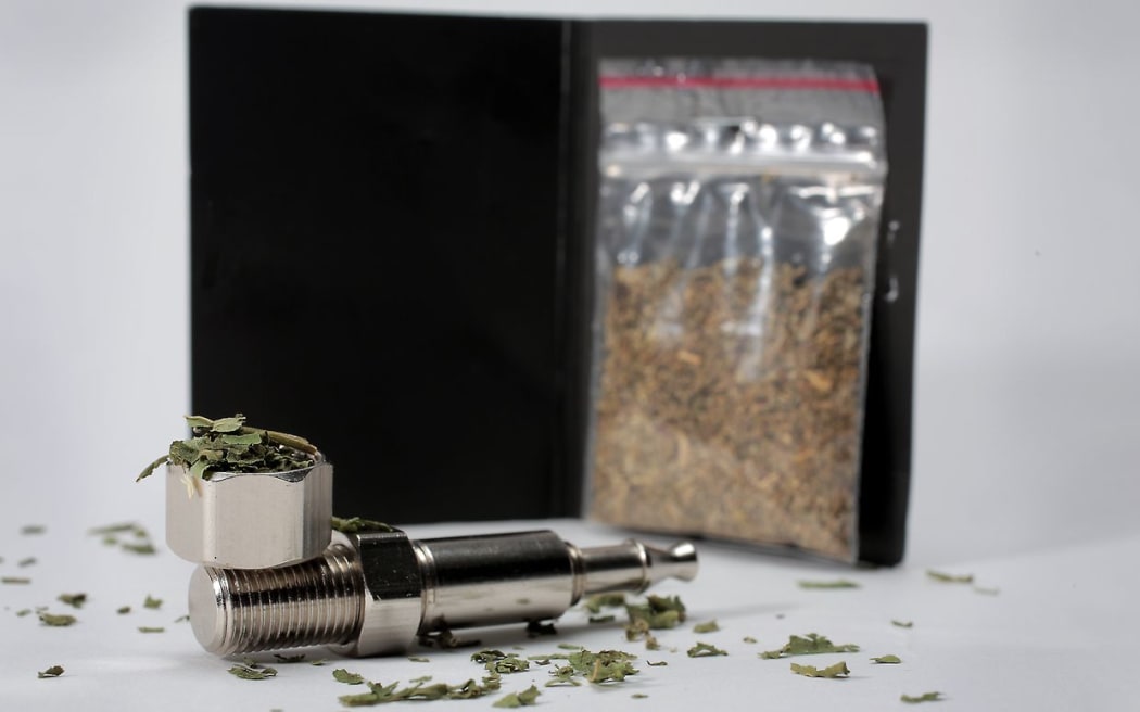 Synthetic cannabis and a pipe.