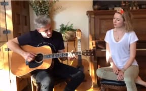 A screenshot of an Instagram video posted by Kiwi singer Hayley Westenra of herself singing with Thomas Deluca playing a guitar.