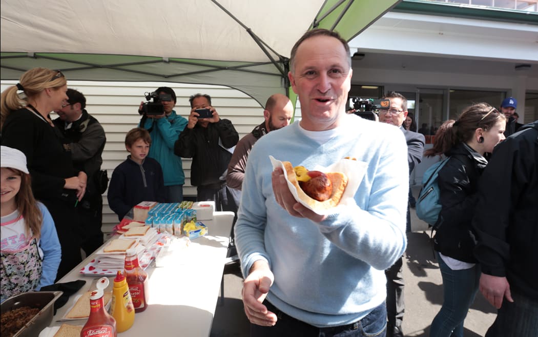 John Key relaxing after casting his vote near his home in Auckland.
