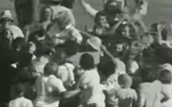 When he reached his century, members of the crowd ran on and jostled and hoisted Redmond.