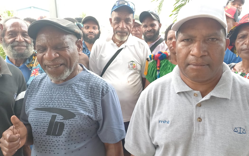 Jacob Ten, right, a serving member of the Royal Papua New Guinea Constabulary is leader of a pilgrimage to Port Moresby to see the Pope.