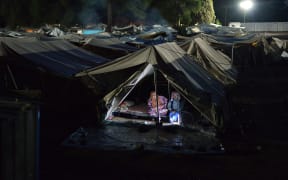 An elderly couple settle in for the night at the Ritsona refugee camp.