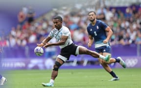 Fiji’s Terio Veilawa launches an attack against the France defense on day two of the Paris 2024 Olympic Games at Stade de France on 25 July, 2024 in Paris. Photo credit: Mike Lee - KLC fotos for World Rugby