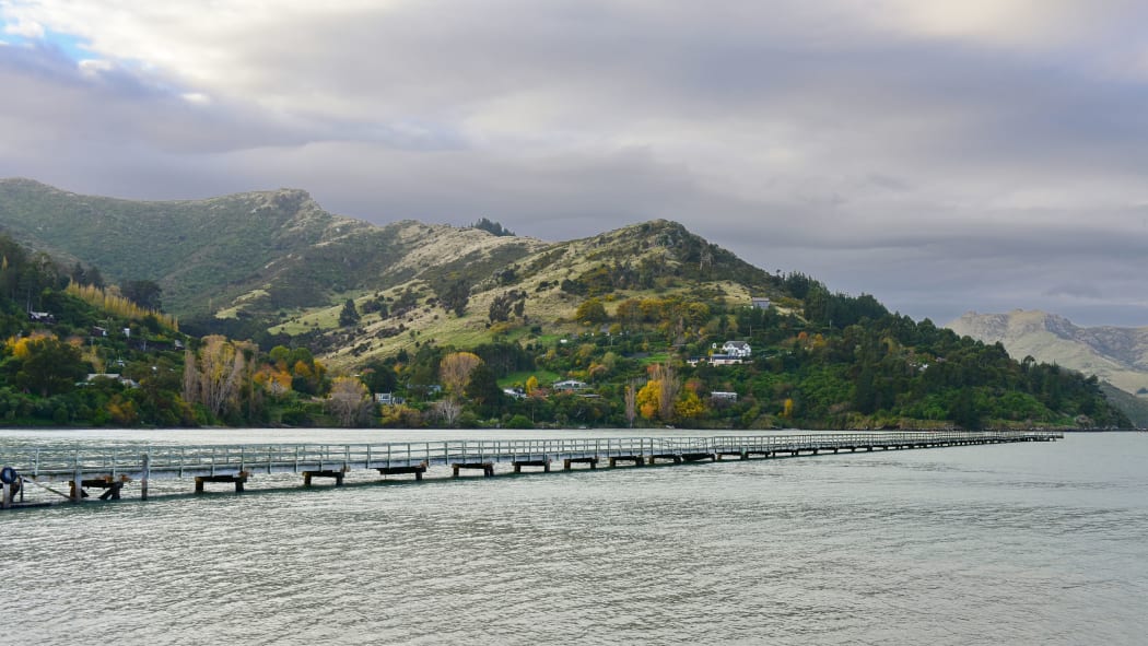 Governors Bay jetty and Port Hills in the background in Christchurch, New Zealand