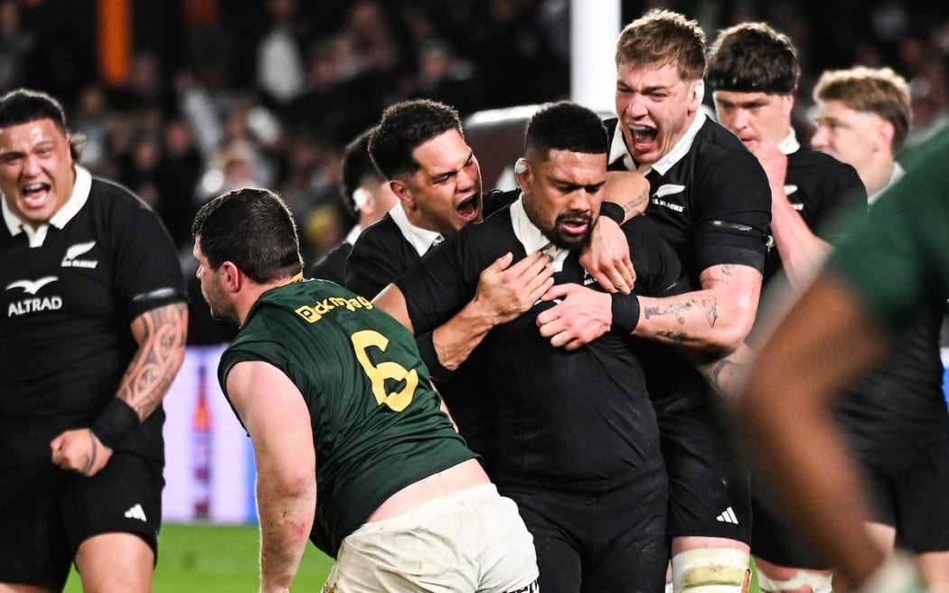 Aridie Savea wins a penalty and celebrates with Quinn Tupaea and Fabian Holland.
